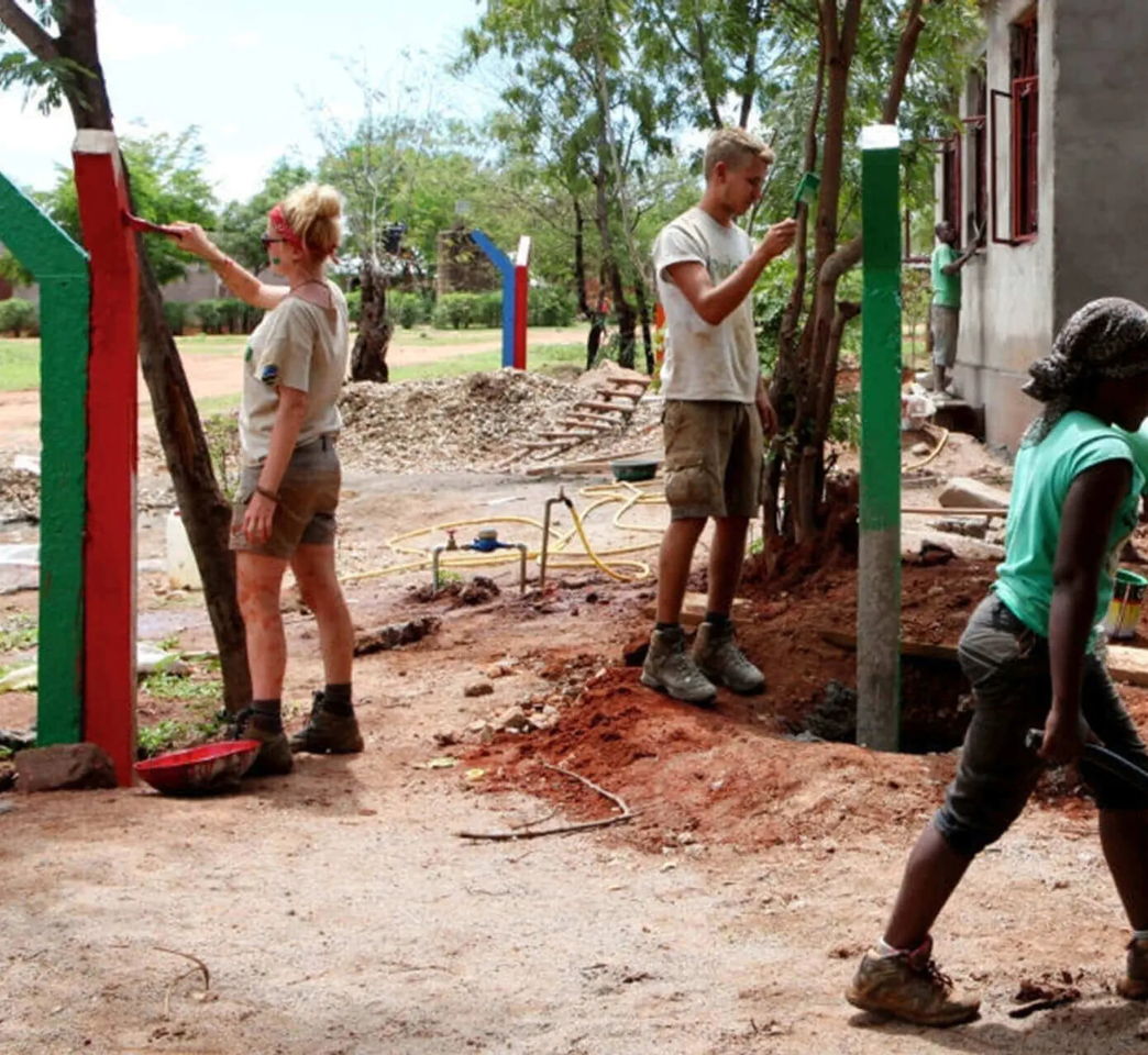 Volunteers painting a building