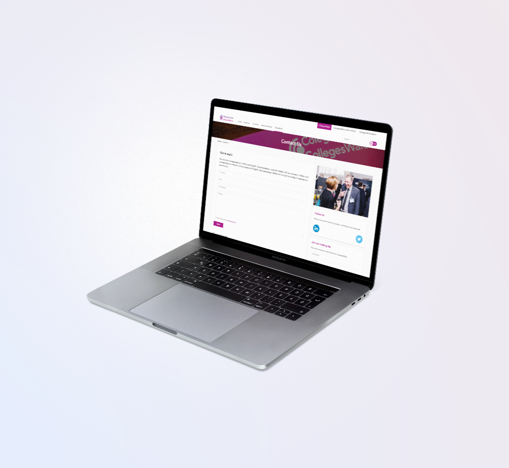 A laptop displaying a website with text and images. The screen shows a form and a section with a photo on the right. The laptop is open and positioned at an angle.
