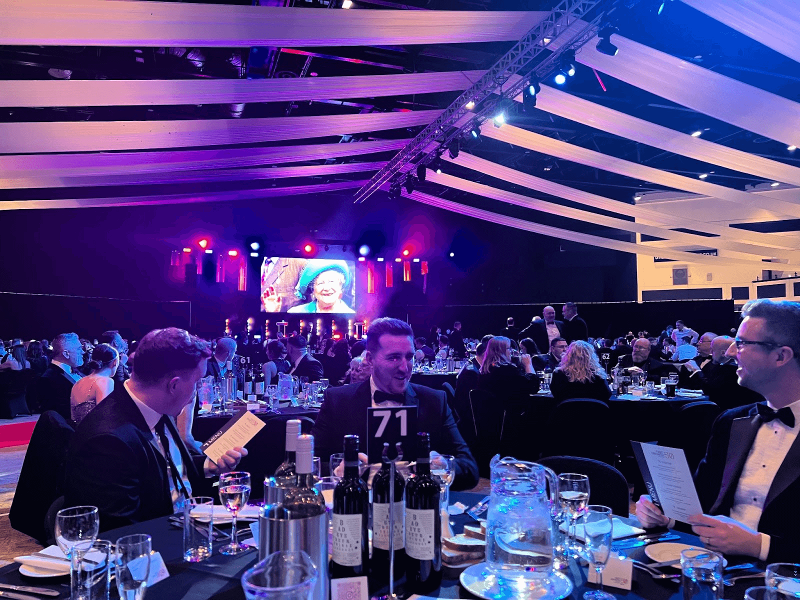People at a table during an awards ceremony.