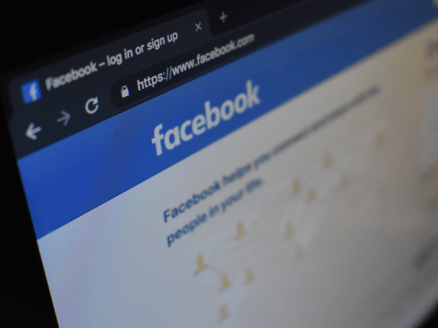 Close-up of a computer screen displaying the Facebook log-in or sign-up page with the URL visible in the browser's address bar.